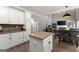 Open kitchen layout with island, white cabinets, granite counters, and backyard access at 1504 Oglethorpe Dr, Suwanee, GA 30024