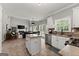 Open-concept kitchen featuring island, stainless steel appliances and view of living room at 1504 Oglethorpe Dr, Suwanee, GA 30024