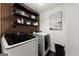 Modern laundry room with new machines and storage at 1504 Oglethorpe Dr, Suwanee, GA 30024