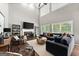 Bright living room boasts soaring ceilings, fireplace, and lots of natural light at 1504 Oglethorpe Dr, Suwanee, GA 30024