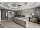 Cozy main bedroom with tray ceiling, neutral tones, and a glimpse of the ensuite bathroom at 1504 Oglethorpe Dr, Suwanee, GA 30024