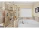 Bathroom with a bathtub and a shower stall featuring tile surround at 1442 Swiftwater Cir, Mcdonough, GA 30252