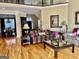 Cozy living room boasts hardwood floors, a fireplace, and seamless flow into the adjacent dining area at 1442 Swiftwater Cir, Mcdonough, GA 30252