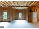 Bright unfinished basement framed with two windows and a white exterior door allowing ample natural light at 5490 Bent Grass Way, Douglasville, GA 30135