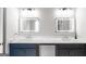 Modern bathroom featuring double sinks with quartz countertops and sleek, lighted mirrors at 5490 Bent Grass Way, Douglasville, GA 30135
