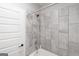 Bathroom featuring neutral tiled shower with modern fixtures at 5490 Bent Grass Way, Douglasville, GA 30135