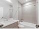 Bathroom featuring sleek white tiled walls, modern fixtures and a combined shower and tub at 5490 Bent Grass Way, Douglasville, GA 30135