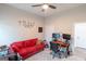 Inviting bedroom with a comfortable red sofa, desk setup, and ample natural light at 5490 Bent Grass Way, Douglasville, GA 30135
