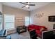 Inviting bedroom with comfortable red sofa, two bright windows, and ample natural light at 5490 Bent Grass Way, Douglasville, GA 30135