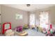 Playroom with rainbow curtains, slide and assorted toys, creating a vibrant space at 5490 Bent Grass Way, Douglasville, GA 30135