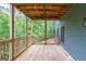 View of a spacious wooden deck with railing, perfect for outdoor entertaining, surrounded by lush greenery at 5490 Bent Grass Way, Douglasville, GA 30135