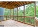 Wooden deck overlooks a lush green forest, providing a serene outdoor space for relaxation and enjoyment at 5490 Bent Grass Way, Douglasville, GA 30135