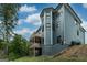 View of home's exterior featuring upper and lower wooden decks and painted foundation at 5490 Bent Grass Way, Douglasville, GA 30135