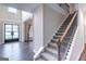 Welcoming foyer with high ceilings, staircase, and hardwood flooring creates a grand entrance at 5490 Bent Grass Way, Douglasville, GA 30135