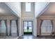 Grand foyer with soaring ceilings, a statement door, and luxury flooring at 5490 Bent Grass Way, Douglasville, GA 30135