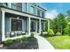 Charming front porch with seating, stone accents, and manicured landscaping enhancing curb appeal at 5490 Bent Grass Way, Douglasville, GA 30135