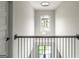 Upstairs hallway featuring modern light fixture and outdoor view at 5490 Bent Grass Way, Douglasville, GA 30135