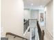 Upstairs hallway featuring a decorative railing with carpeted floors and neutral paint at 5490 Bent Grass Way, Douglasville, GA 30135