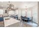 A kitchen with a large island, modern appliances, and a dining area with plenty of natural light at 5490 Bent Grass Way, Douglasville, GA 30135