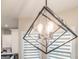 A modern light fixture hangs over the kitchen island, showcasing the stylish design and bright illumination at 5490 Bent Grass Way, Douglasville, GA 30135