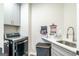 Well-organized laundry room with modern washer/dryer, sink, and functional storage solutions at 5490 Bent Grass Way, Douglasville, GA 30135