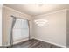 Bright room with hardwood floors, modern lighting, and window with custom shades at 5490 Bent Grass Way, Douglasville, GA 30135