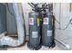 Two gray Rheem water heaters installed with associated piping on concrete floors in the basement at 5490 Bent Grass Way, Douglasville, GA 30135