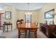 Comfortable dining room with a wooden table, light fixture, and ample natural light at 55 Helen Ln, Stockbridge, GA 30281