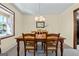Inviting dining room featuring a wooden table, chandelier, and natural light at 55 Helen Ln, Stockbridge, GA 30281