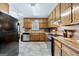 Well-equipped kitchen featuring wooden cabinetry, stainless steel appliances, and vinyl flooring at 55 Helen Ln, Stockbridge, GA 30281