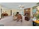 Spacious living room featuring a brick fireplace, ceiling fan, and neutral carpet at 55 Helen Ln, Stockbridge, GA 30281