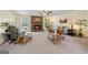 Bright living room with a cozy fireplace, ceiling fan, and neutral carpet at 55 Helen Ln, Stockbridge, GA 30281
