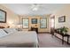 Comfortable main bedroom featuring soft carpet, a ceiling fan, and natural light from dual windows at 55 Helen Ln, Stockbridge, GA 30281