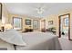 Inviting main bedroom with neutral decor, carpeted floors, and natural light from two large windows at 55 Helen Ln, Stockbridge, GA 30281