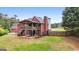 Spacious backyard of a two-story brick home featuring an upper deck, patio, and lush green lawn at 1112 Haver Ct, Mcdonough, GA 30252