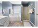 Primary bathroom featuring a soaking tub, walk-in shower, white cabinets and tile floors at 1112 Haver Ct, Mcdonough, GA 30252