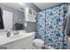 Cozy bathroom features a vanity with sink, a white toilet, and a blue patterned shower curtain at 1112 Haver Ct, Mcdonough, GA 30252