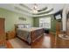 A spacious primary bedroom featuring wood floors, tray ceilings, and a ceiling fan at 1112 Haver Ct, Mcdonough, GA 30252