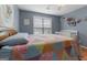 Comfortable bedroom with ceiling fan, hard wood floors, double window, crib and a quilt-covered bed at 1112 Haver Ct, Mcdonough, GA 30252