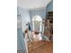 Bright entryway featuring hardwood stairs, a chandelier, and blue accent walls at 1112 Haver Ct, Mcdonough, GA 30252