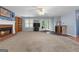 Expansive living room with a fireplace, built-in bookshelves, and ample natural light from the windows at 1112 Haver Ct, Mcdonough, GA 30252