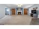 Expansive living room with a fireplace, built-in bookshelves, and ample natural light from the windows at 1112 Haver Ct, Mcdonough, GA 30252