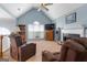 Cozy living room featuring a fireplace, plush recliners, and large windows offering natural light at 1112 Haver Ct, Mcdonough, GA 30252
