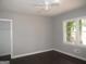 Bright bedroom with hardwood floors, a ceiling fan, and natural light from a large window at 1876 Sw Sandtown Sw Rd, Atlanta, GA 30311