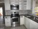 Updated kitchen featuring stainless steel appliances and white cabinetry for a modern feel at 1876 Sw Sandtown Sw Rd, Atlanta, GA 30311