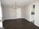 Spacious living room with hardwood floors, a decorative chandelier, and a view of the kitchen at 1876 Sw Sandtown Sw Rd, Atlanta, GA 30311