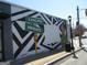 Exterior wall featuring a striking mural with geometric designs and the Cascade Heights sign near the sidewalk at 1876 Sw Sandtown Sw Rd, Atlanta, GA 30311