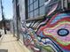 Exterior wall featuring a vibrant and colorful mural painted on a brick building near the sidewalk at 1876 Sw Sandtown Sw Rd, Atlanta, GA 30311