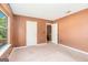 Neutral bedroom with a window, with an open door to the hallway and a closet at 548 Thomas Downs Way, Jonesboro, GA 30238