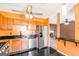 Modern kitchen featuring stainless steel appliances, dark countertops and bright orange walls at 548 Thomas Downs Way, Jonesboro, GA 30238